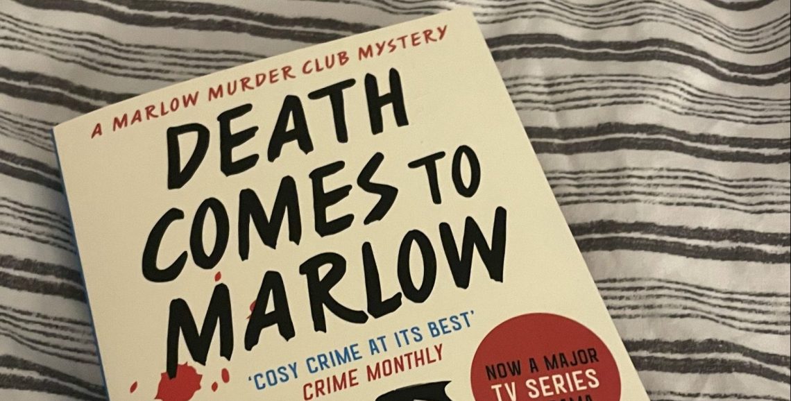 Death comes to Marlow book on a striped bed